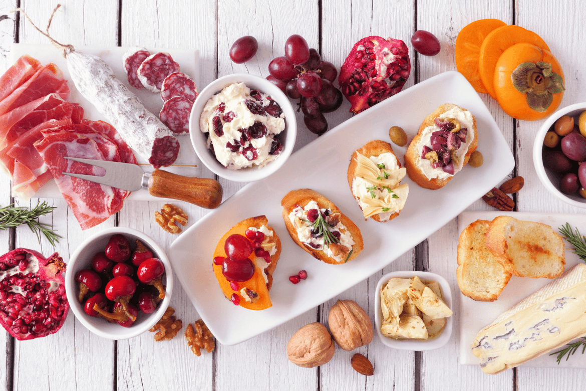 A delightful spread of various appetizers arranged on a clean white table, perfect for sharing at a gathering