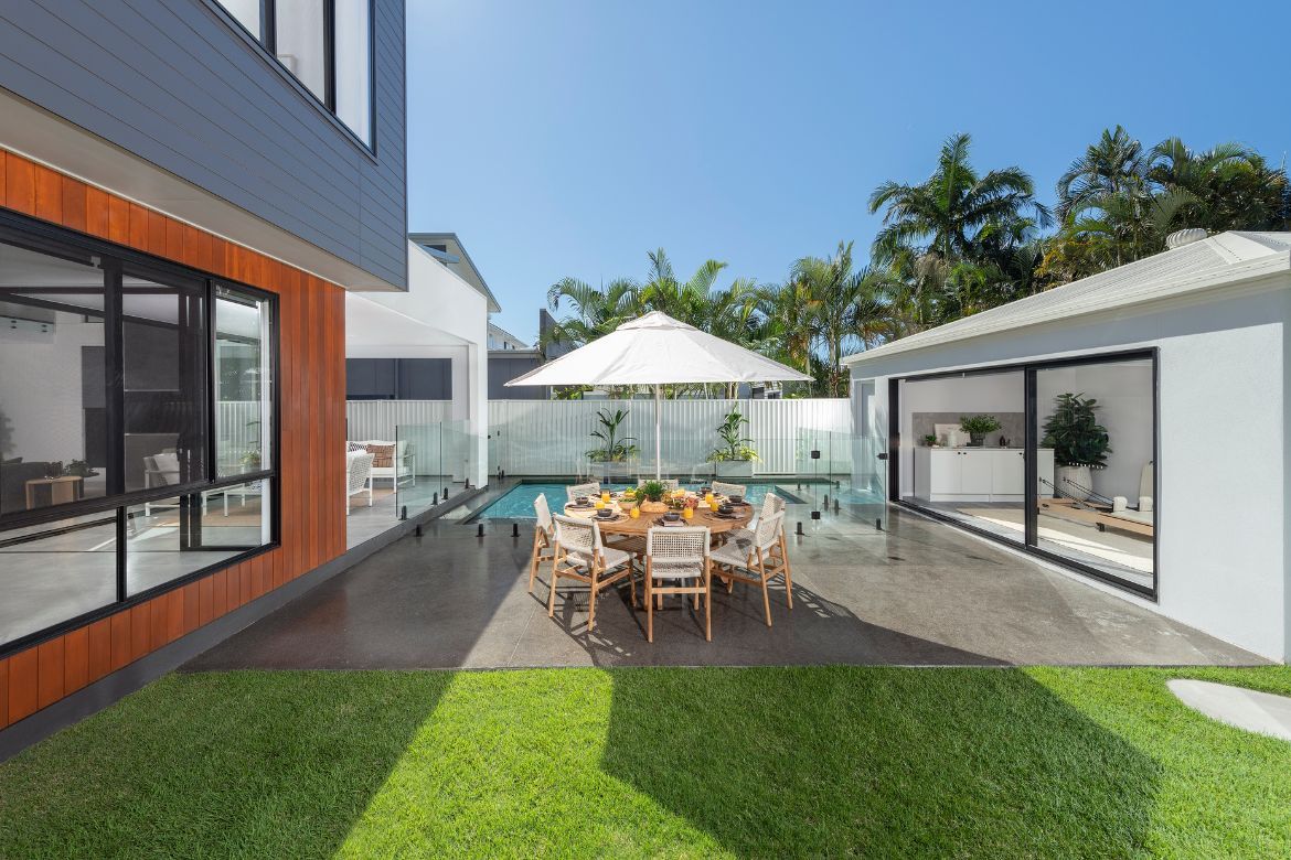 Outdoor entertaining area at Prize Home 469 with alfresco dining, lawn and magnesium pool in Golden Beach.