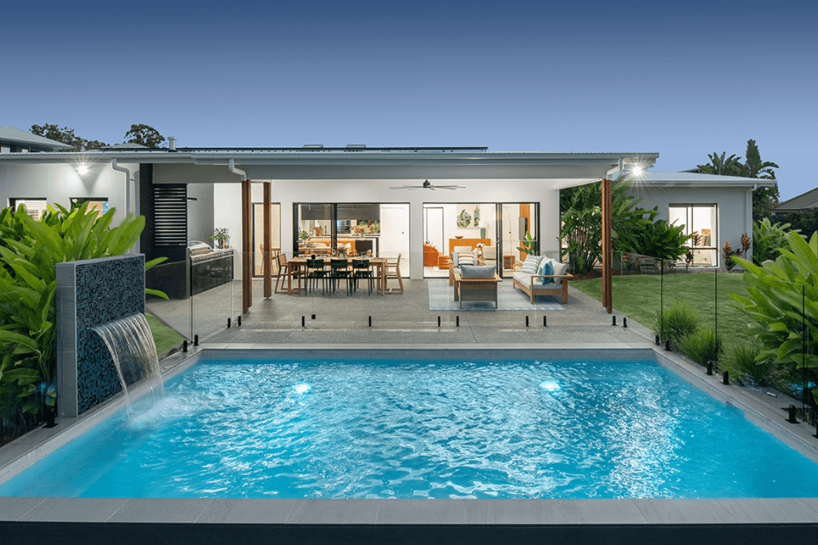 Modern house with pool, patio, and large open living space visible at dusk.